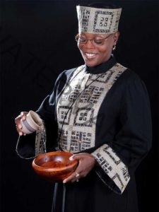 Maryland officiant Starlene, wearing a clergy robe, pouring a libation to honor African American ancestral traditions during a wedding ceremony